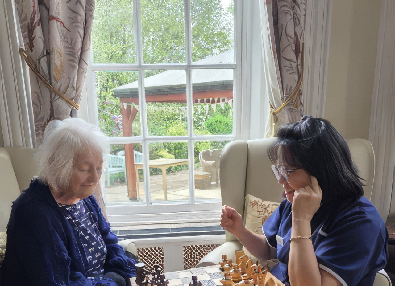 Residents playing chess by the window