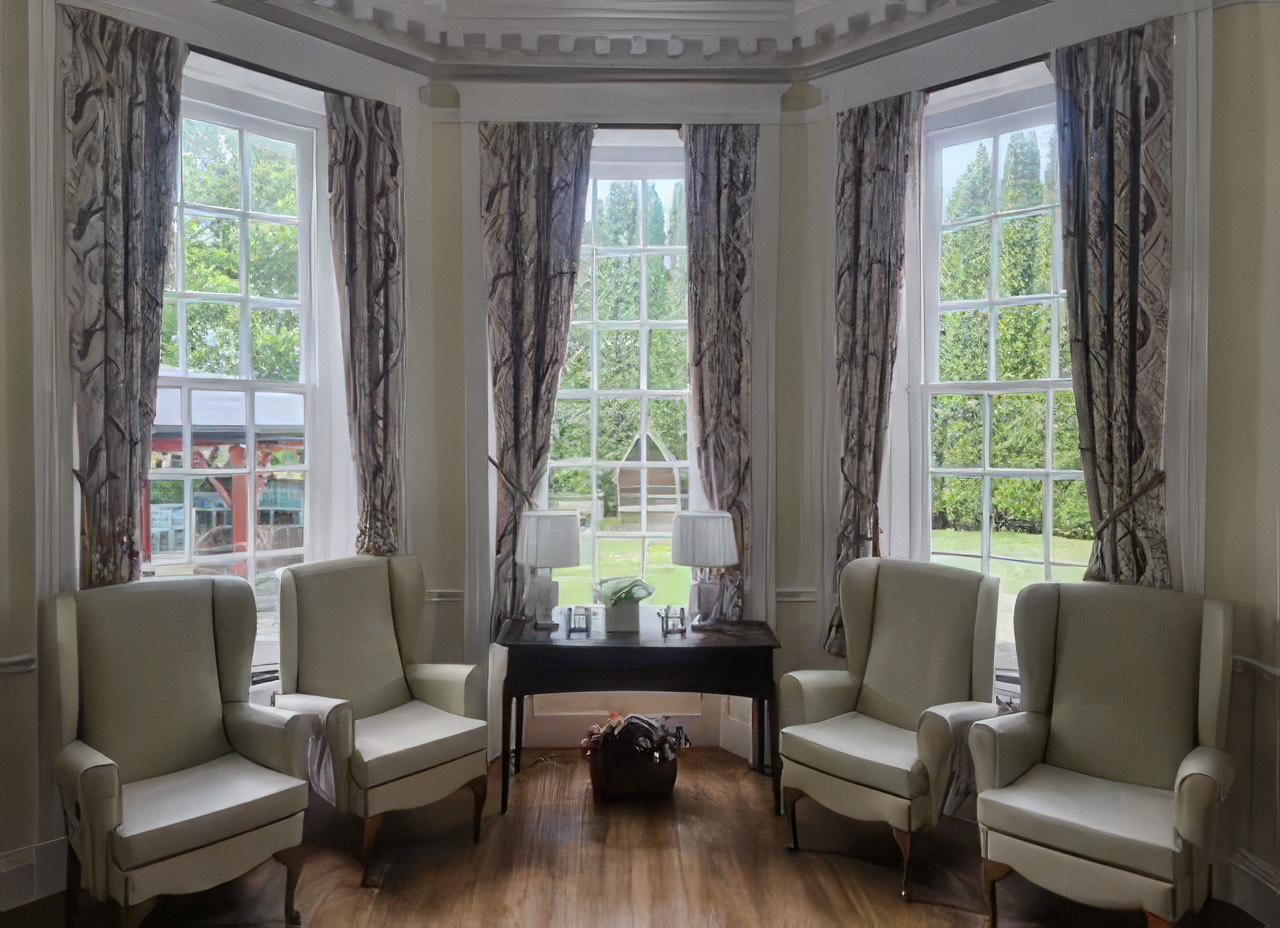 A bright lounge with bay windows overlooking the gardens